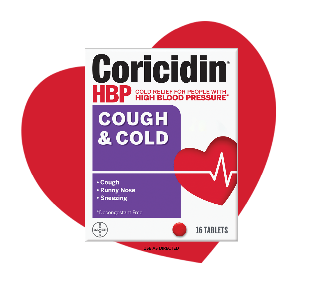 Pack of Coricidin® HBP Cough & Cold medicine is placed on a red heart with the label which says that it provides cold relief for people with high blood pressure* and relieves cough, runny nose, and sneezing. The pack features a red heart with a heartbeat line and a red tablet icon. The text on the pack also says that it's a *Decongestant free and contains 16 tablets.